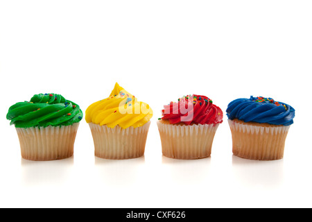 Row of brightly colored cupcakes on a white background Stock Photo