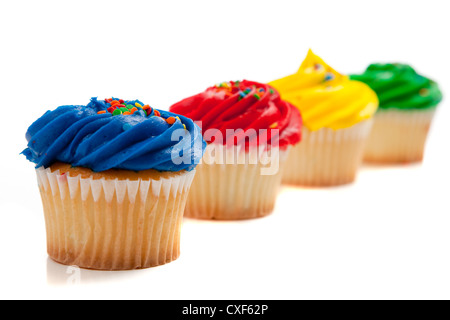 Row of brightly colored cupcakes on a white background Stock Photo