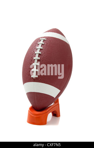 American football on kicking tee on field with goal post in background  Stock Photo - Alamy