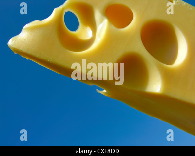 Cholesterol attack. Conceptual image of cheese on blue sky background Stock Photo