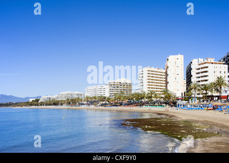 Beach and apartment buildings in resort town of Marbella on Costa del Sol in Spain, Andalusia, Malaga province. Stock Photo