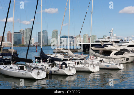 Sailboats, yachts, and pleasure boats docked in North Cove Marina in New York City with Jersey City, NJ across the Hudson River. Stock Photo