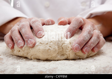 Hands kneading dough Stock Photo
