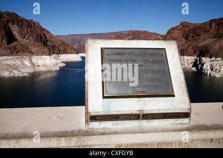 Memorial Plaque affixed to the top of Hoover Dam, on the Dividing Line Between Arizona and Nevada, Lake Mead in the Background Stock Photo