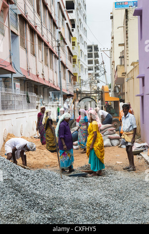 Indian men and women working on the roads in Puttaparthi, Andhra Pradesh, India. Stock Photo