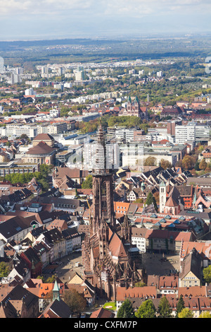 Old houses and minster with high tower of gothic town, Freiburg im Breisgau minster Germany. Stock Photo