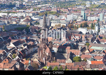 Old houses and minster with high tower of gothic town, Freiburg im Breisgau minster Germany. Stock Photo