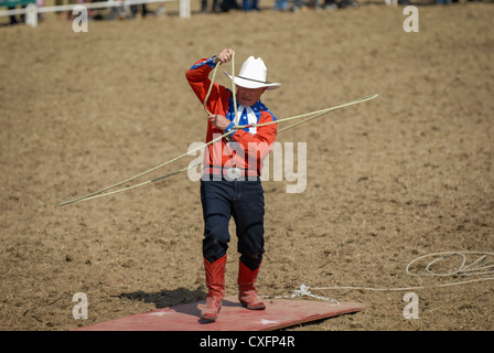 Cowboy spinning a lasso at a rodeo Stock Photo