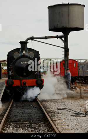 Steam Locomotive at Buckinghamshire Railway Centre, Quainton, takes on water from the water crane Stock Photo