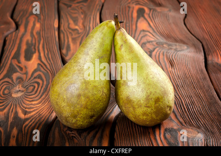 Two pears on an old brown wooden background Stock Photo
