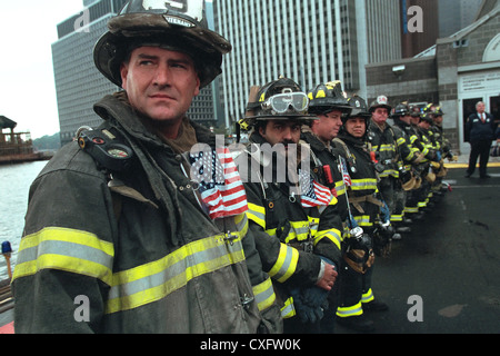 Firefighters await the arrival of US President George W. Bush at the site of the destroyed World Trade Center September 14, 2001 in New York City. Bush addressed recovery workers and rallied the nation following terrorist attacks. Stock Photo