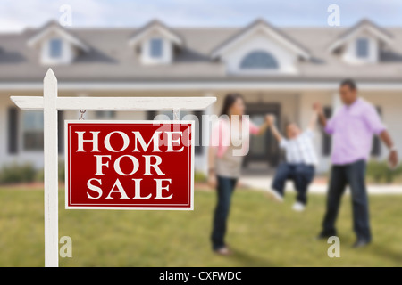 Sold Real Estate Sign and Playful Hispanic Family in Front of House ...