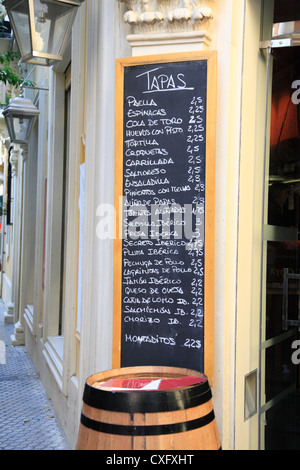 Extensive Tapas menu outside a restaurant bar in the old part of Seville Spain written in chalk on a blackboard Stock Photo