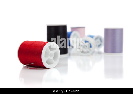 Row of various colored spools of thread Stock Photo