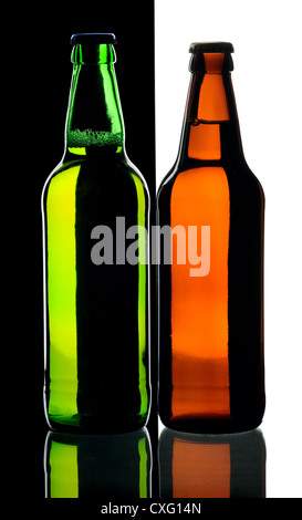 Bottles of lager beer from green and brown glass, isolated on a black and white background. Stock Photo
