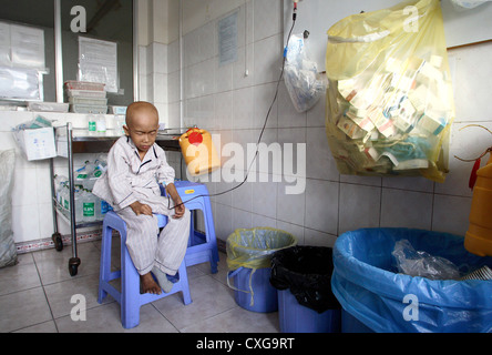 Crying child with chemotherapy on a cancer ward in Saigon Stock Photo