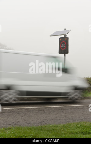 Speeding motorists passing through an activated radar warning at 40mph cruising above seed limit poor visibility due to mist Stock Photo
