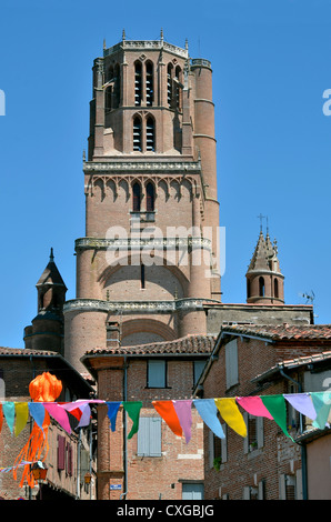 Bell tower made in red bricks of the Sainte Cécile cathedral made in red bricks at Albi and flags, in southern France Stock Photo