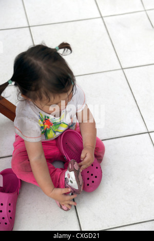 Eighteen Month Old Child Trying On Adult Shoes Crocs England Stock Photo