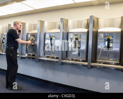 Mature Man Using Public Pay Phone,Newark Liberty International Airport, Newark, New Jersey, USA Stock Photo