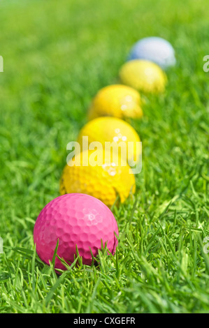 six golf balls on the green grass Stock Photo