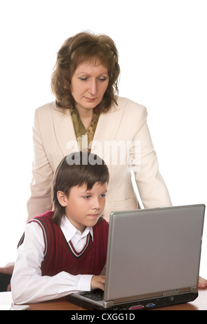 Female teacher and boy using laptop in class at school Stock Photo - Alamy