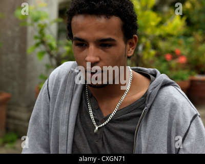 Portrait Of Young Man Mixed Race In His Early Twenties Looking Surprised Stock Photo