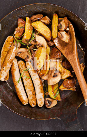 fried sausages with potato and mushrooms Stock Photo