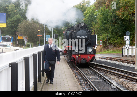 Steam locomotive and a railway worker. The Molli bahn at Bad Doberan - Germany Stock Photo