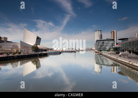 The imperial war museum, media city and the Lowry theater reflected in the calm waters of Salford Quays