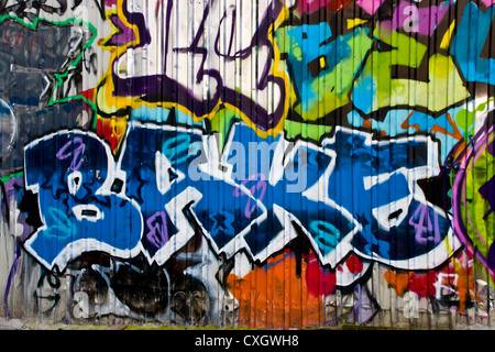 Vibrant urban graffiti street art with word bake on metal wall London England Europe Stock Photo