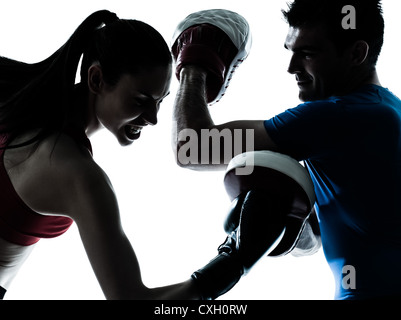 personal trainer man coach and woman exercising boxing silhouette  studio isolated on white background Stock Photo