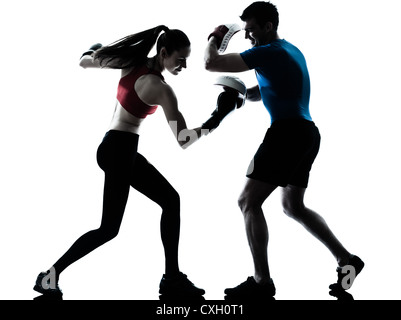 personal trainer man coach and woman exercising boxing silhouette  studio isolated on white background Stock Photo