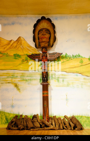 A colorful carved Totem bird, in interior Saloon Western City from the days of the wild west Seville, Spain Stock Photo