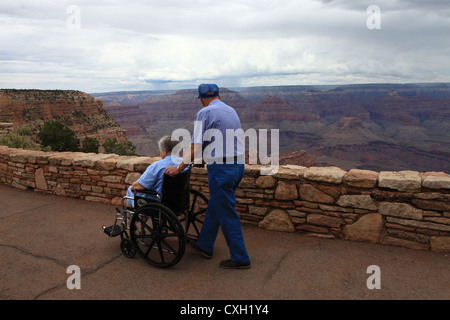 Senior man pushing his wife in wheelchair at Grand canyon national park, Arizona, USA Stock Photo