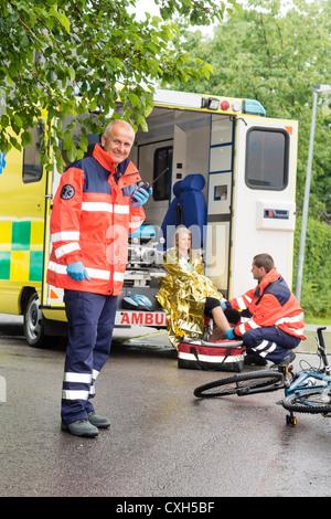 Accident bike woman get emergency help paramedics in ambulance Stock ...