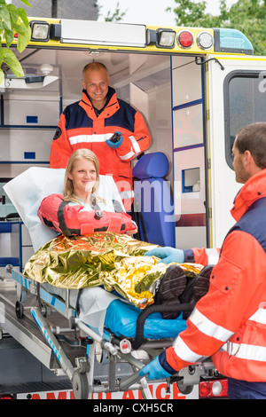 Emergency paramedics helping woman in ambulance bike accident thermal ...