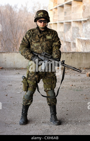 Young handsome soldier (sniper) aiming a machine gun Stock Photo - Alamy