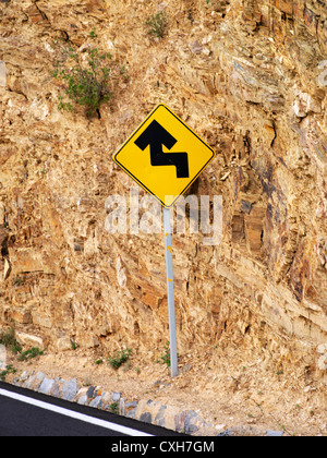 A highway sign indicating a zig-zag in the road Stock Photo