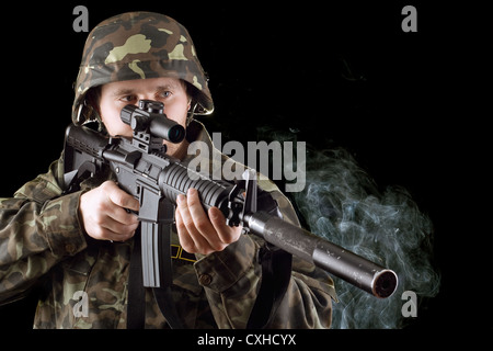 Soldier with the smoking gun Stock Photo