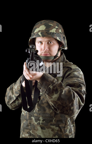 Armed man pointing a rifle Stock Photo