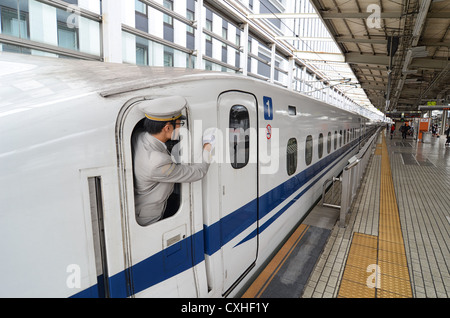 Japanese train conductor working on the bullet train (shinkansen). Stock Photo