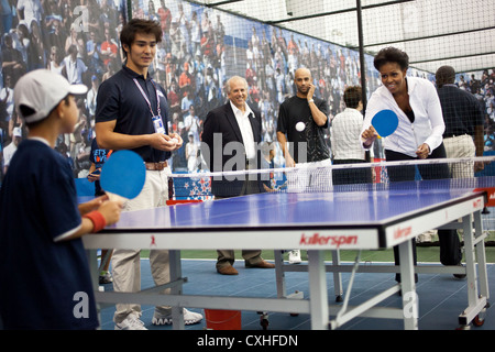 First Lady Michelle Obama plays table tennis during a Let's Move event September , 2011 at the USTA Billie Jean King National Tennis Center in New York. Stock Photo