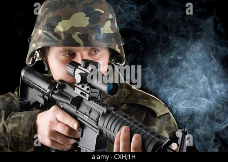 Soldier with the smoking gun. Closeup Stock Photo