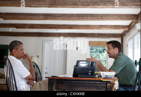 US President Barack Obama receives an economic briefing from Brian Deese, Deputy Director of the National Economic Council August 24, 2011 at the Fisher House at Blue Heron Farm in Chilmark, Massachusetts. Stock Photo