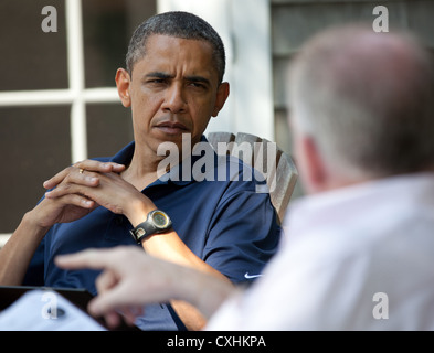 US President Barack Obama receives a national security briefing from John Brennan, Assistant to the President for Counterterrorism August 19, 2011 in Martha's Vineyard, Massachusetts. Stock Photo