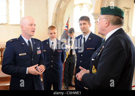 EAST HORNDON, England--Capt. John Williams, 351st Air Refueling Squadron, speaks with Mike Hughes,former Royal Marines Commando, prior to a remembrance service Sept. 29, 2012, at the Church of All Saints. This service was to commemorate the 69th anniversary of the Sept. 26, 1943, air disaster involving the Dorsal Queen and Raunchy Wolf. The two B-17 Flying Fortresses collided killing 21 Americans who were returning to England following a bombing mission during World War II. Stock Photo