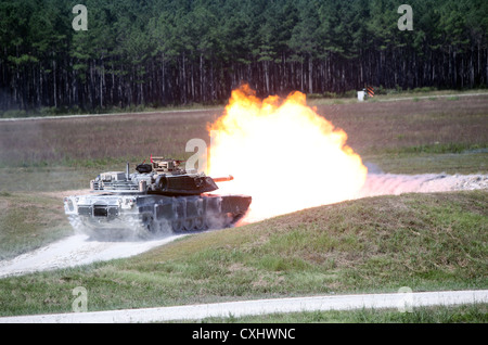 An M1A1 Main Battle Tank fires from its main gun Sept. 26 during a practice shoot for the 2012 Tiger Competition aboard Camp Lejeune. The next day, a crew from 2nd Tank Battalion, 2nd Marine Division, consisting of Sgt. Linh Ngo, tank commander; Cpl. Ryan Hanna, gunner; Lance Cpl. Delio Linares, loader; and Lance Cpl. Domenic Kalaski, driver, defeated crews from 1st Tank Battalion and 4th Tank Battalion to win the tournament and capture the Gunnery Sergeant Robert H. McCard Cup. Stock Photo