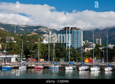 Yalta harbor waterfront with docked sailboats in summer. Stock Photo