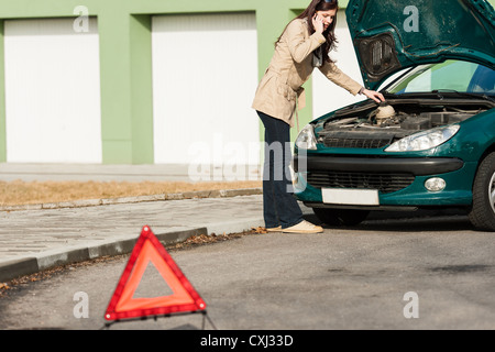 Car breakdown couple calling for road assistance look engine Stock Photo